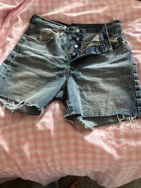 Levi's Medium Blue Frayed Denim Cutoff Shorts